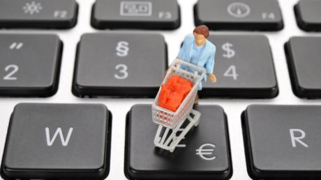 Symbolbild Online-Shopping: Eine Miniaturfigur mit einem Einkaufswagen auf der Tastatur © imago/imagebroker