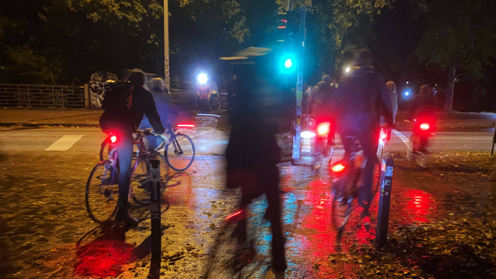 Fahrradfahrer*innen stehen abends an einer Ampel © imago images/Hoch Zwei Stock/Angerer