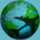 Flugzeug wirft Schatten über den Globus © imago images/Ikon Images