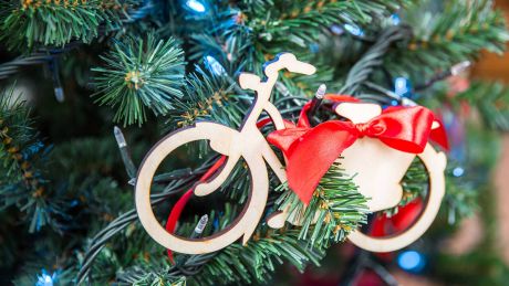 Ein Fahrrad-Anhänger hängt an einem Weihnachtsbaum © IMAGO/YAY Images