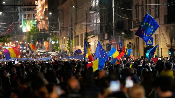 Anhänger des Präsidentschaftskandidaten Nicușor Daniel Dan feiern auf der Straße nach Schließung der Wahllokale für die zweite Runde der Präsidentschaftswahlen © picture alliance/dpa/AP | Vadim Ghirda