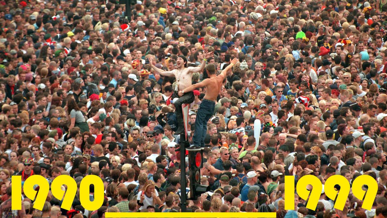 Auf einem Verkehrsschild und einer demolierten Ampelanlage tanzen am 11.07.1998 in Berlin zwei Raver auf der Love Parade